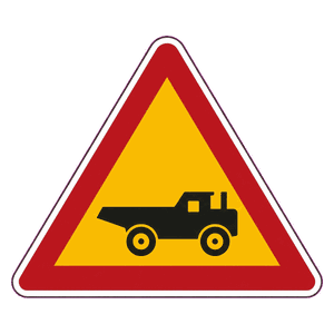 Construction vehicles crossing (from left) road sign
